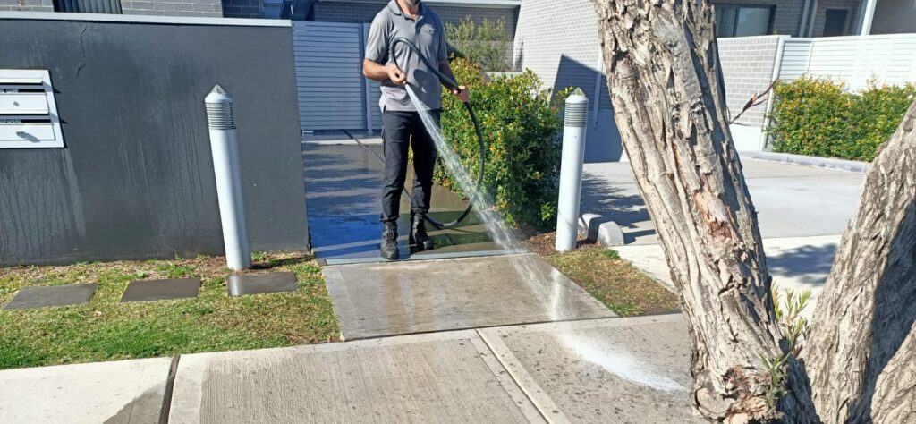 vipfs employee cleaning the driveway with high pressure washing